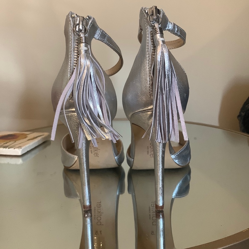 Worn silver metallic heels
